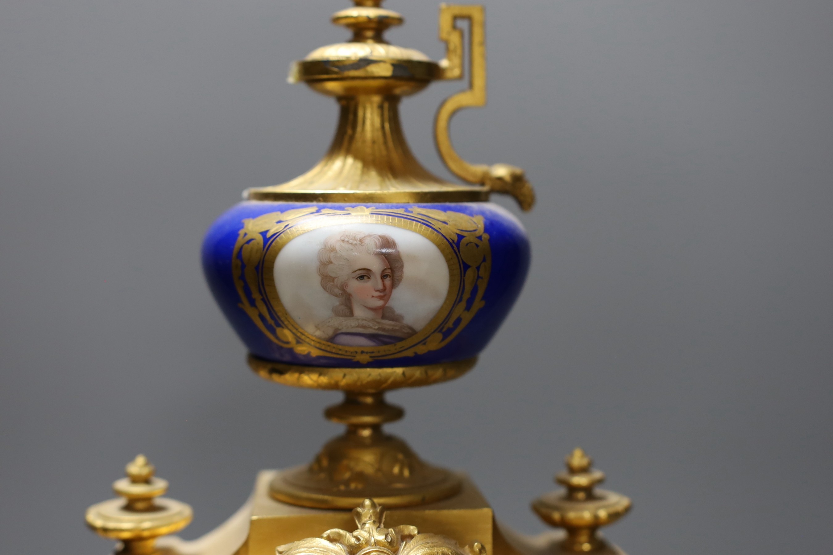 A 19th century French gilt metal and Sevres style enamel mantel clock, 37cm wide